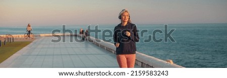 Similar – Two women walking by sea pier