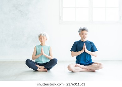 Asian sporty senior couple in the room - Powered by Shutterstock