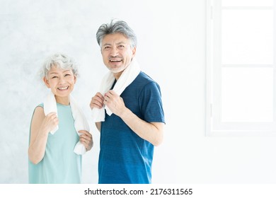 Asian sporty senior couple in the room - Powered by Shutterstock