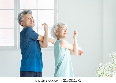Asian sporty senior couple in the room - Shutterstock ID 2176311571