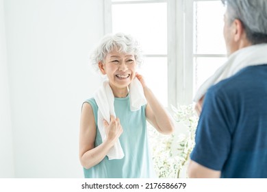 Asian sporty senior couple in the room - Powered by Shutterstock