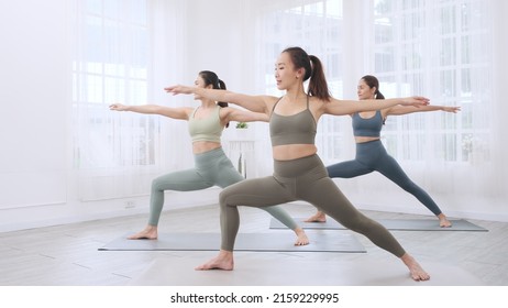 Asian Sporty Woman Group  Learning Yoga Class With Instructor.
