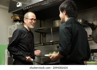 Asian Staff Teaching Work At A Restaurant