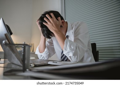 Asian Stress Business Man Tired And Worried In Office At Late Night
