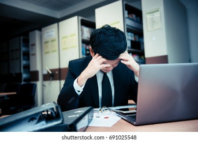 Asian stress business man working fail,The owner of the company blamed him with bad word,Thai employee serious from hard work from boss,Sad handsome guy in black suit - Shutterstock ID 691025548