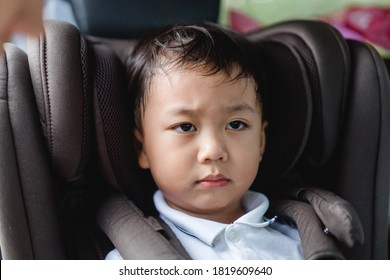 Asian Stubborn Child Baby Boy While Mother Scolding On Car Seat In The Car When He Go Back To School In The Morning.Little Asian Toddler Boy In Booster Seat Make Boring Face.Transportation Safe Trip.