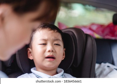 Asian Stubborn Child Baby Boy While Mother Scolding On Car Seat In The Car When He Go Back To School In The Morning.Little Asian Toddler Boy In Booster Seat Make Crying Face.Transportation Safe Trip.