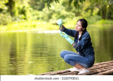 Asian Student Biology Taking And Testing Sample Of Natural River Water.  Experts Science Women Keep Water For Research Analysis In The Laboratory.  Environmental Pollution Concept