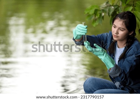 Asian student biology taking and testing sample of natural river water. Experts science women keep water for research analysis in the laboratory. Environmental pollution Concept