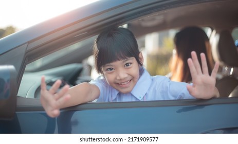 Asian Student Girl Ready To Go To School And Waving Goodbye Or Say Hi On Car Background. Back To School Concept.