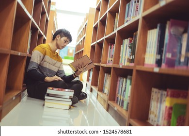 Asian student reads book in the library, lessons for exams, educational concepts - Shutterstock ID 1524578681