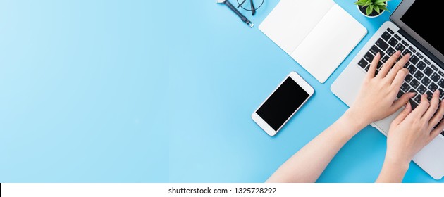 Asian Student Surf Internet For Job Hunting. Freelancer Blog Writer Typing Isolated On A Minimal Clean Blue Desk Concept, Workspace, Copy Space, Flat Lay, Top View, Mock Up