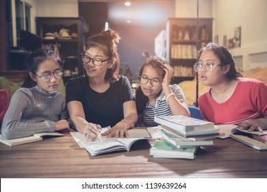 Asian Student And Teacher Explain Study Case In Modern Class Room