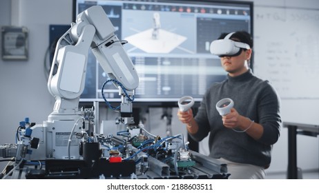 Asian Student Testing Interface of Bionic Hand. Engineer Wearing Virtual Reality Headset and Using Controllers at Modern University of Technology Classroom. Virtual Reality Concept