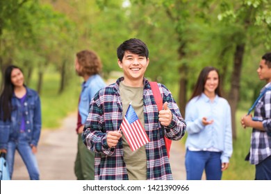 Asian Student With USA Flag Outdoors