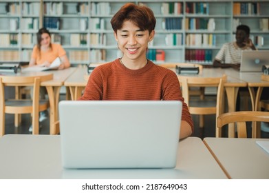 Asian Student Using Laptop In Library