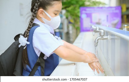 Asian Student  Washing Hands At The Outdoor Wash Basin In The School. Preventing Contagious Diseases, Plague. Kids Health, Protecting The Virus Covid - 19 , Saving Water, Cleaning, Running Water.