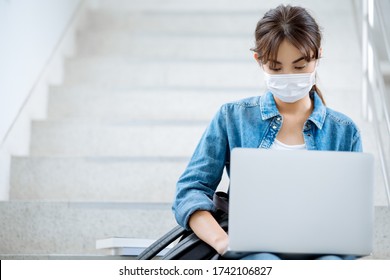 Asian Student Woman Working On A Laptop On Stairs On University Campus And She Wearing Hygienic Mask To Prevent Infection Corona Virus 