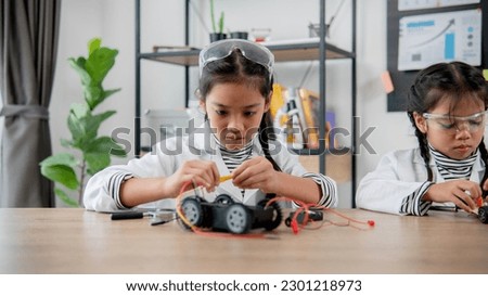 Asian students learn at home in coding robot cars and electronic board cables in STEM, STEAM, mathematics engineering science technology computer code in robotics for kids concept.