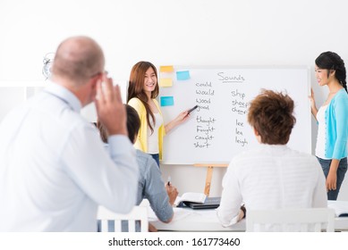 Asian Students Learning The English Language At Class