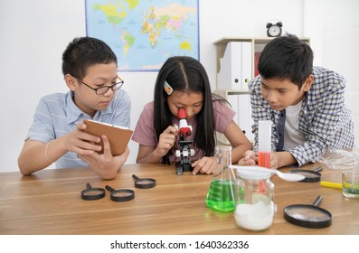  asian students learning to experimentation  in classroom, education concept - Powered by Shutterstock