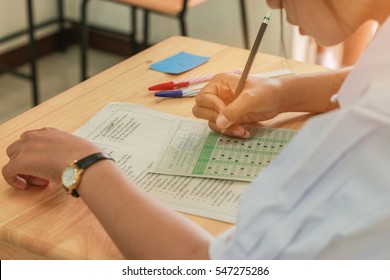 Asian Students Writing Test Exam On Paper For Admissions In High School With Uniform Student In School Classroom Of Thailand, Exam Student Background And Education Concept