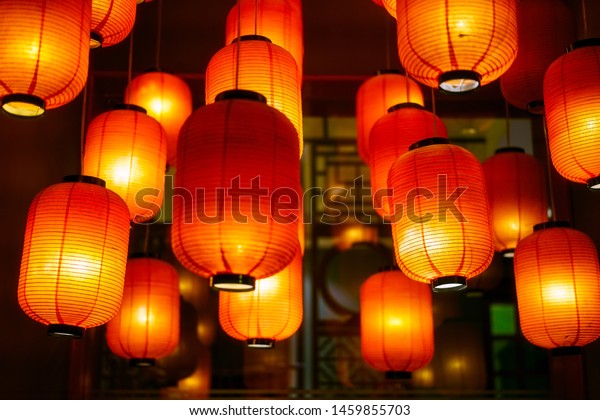 Asian\
style red paper lantern lamps hanging on ceiling\
