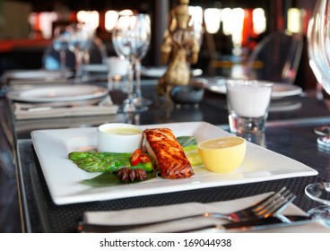 Asian Style Salmon Steak On Restaurant Table