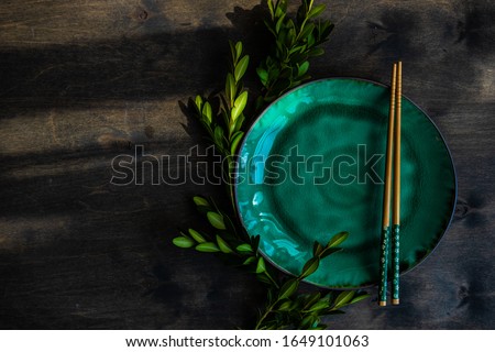 Asian style table setting with cherry blossom and wooden chopsticks