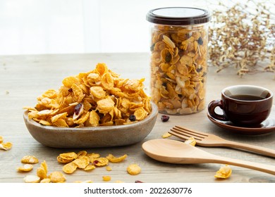 Asian sweet snacks, tasty mixed cornflakes, nut, grape, and caramel on wooden background natural light. packaging of sweet snacks with a cup of tea and copy space. sticker mockup for logo