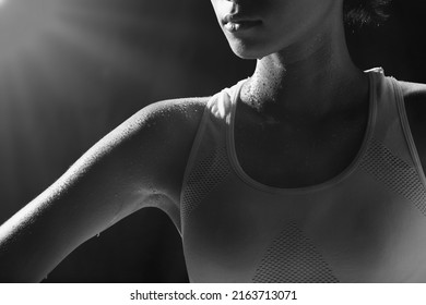 Asian Tan Skin Sport Girl In Fitness Bra, Exercise Sweat Water Drop In Low Key Exposure Lighting. Black Background, Shoulder Part, Concept Woman Can Do