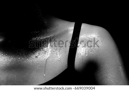 Asian Tan Skin Sport Girl in Fitness Bra long black pants, exercise sweat water drop in low key exposure lighting. black white concept no retouch, shoulder part, woman can do