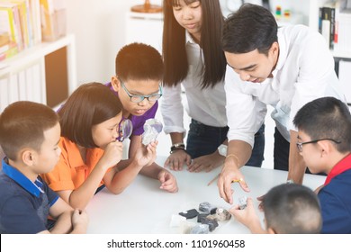 Asian Teacher Expanding To Student In Geology Class With Different Of Rock 