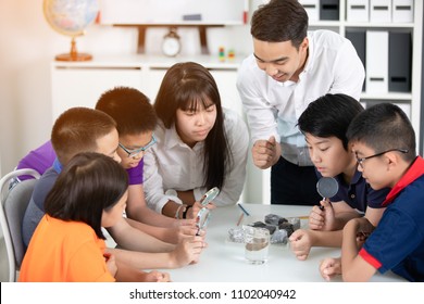 Asian teacher expanding to student in geology class with different of rock . - Powered by Shutterstock