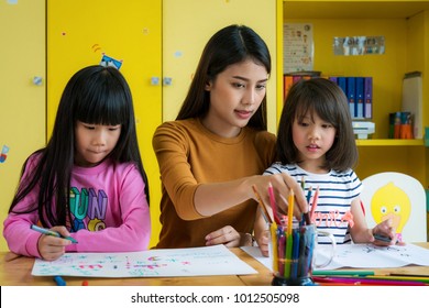 Asian teacher and preschool student in art class, this immage can use for teacher, education, school, student, kid,art, and back to school concept
