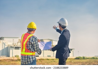 Asian Team Construction Engineers Supervising Progress Of Construction Project Stand On New Factory, Engineering Consulting People On Construction Site Building Inspector.