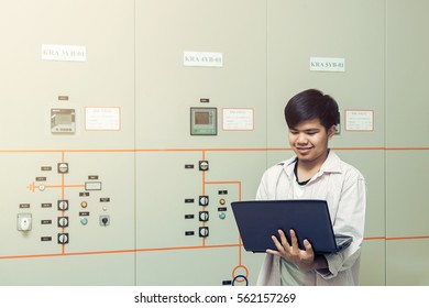 Asian Technician Man Checking  With Computer For Checking Control Room, Vintage Tone  