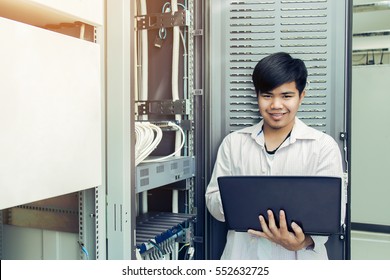 Asian Technician Man Checking LAN Wire With Computer For Checking Control Room, Vintage Tone  