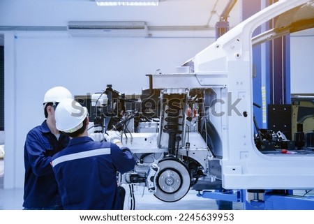 The asian technician repairing or modify the car's engine in the garage. the concept of automotive, repairing, mechanical, vehicle and technology.