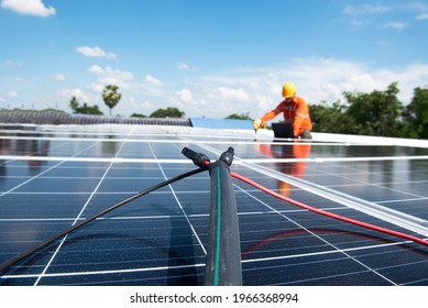 Asian technician Solar panels with a drill to install solar panels on the roof. - Shutterstock ID 1966368994