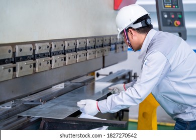 Asian technician worker wearing a safety suit and sheet Metal Bending in industrial factory, Safety first concept. - Powered by Shutterstock