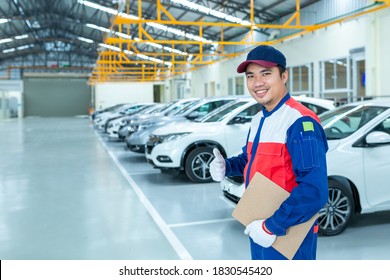 Asian Technicians  Stand Confident In The Car Auto Repair Service Center, Car Mechanic Detailed Vehicle Inspection. 