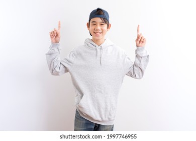 Asian Teen Boy Students Wear Hoodie Pointing Finger Standing On White Background.