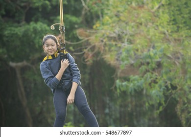 Asian Teen Hanging On Rope For  Adventure Activity