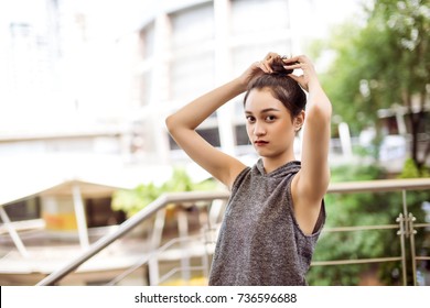 Asian Teen Tying Tie Hair Before Exercise