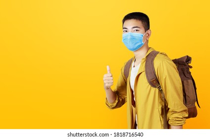 Asian Teenage With Face Mask Get Ready To Aboard For Travel Trip. The Boy Give Thumbs Up And Make Sure He Can Prevent With Covid 19 Or Any Virus