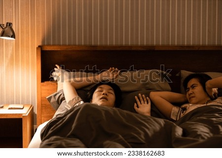 Asian teenage girl snoring in bed having chronic nasal congestion,symptom of obstructive sleep apnea,making a snorting or grunting sound while asleep,sleep disorder,health issues,health care concept