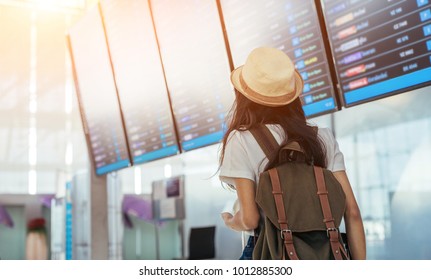 Asian Teenage Girl Is Using A Smartphone To Check Flight At The International Airport To Travel On Weekends.