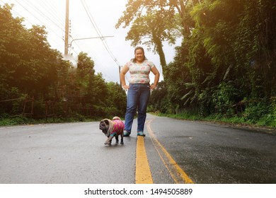 Asian teenage girls travel with cute pug dogs to visit tropical forests on a beautiful natural holiday in Thailand. - Shutterstock ID 1494505889