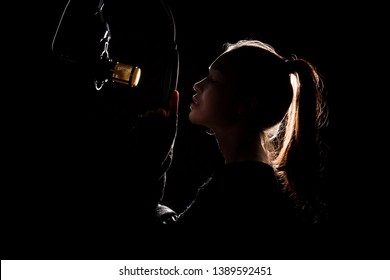 Asian Teenager Adult Woman Black Hair Pony Tail Sing Song Loudly With Power Sound Over Hanging Microphone Condenser Filter In Black Shirt. Studio Back Low Lighting Sound Proof Absorbing Wall Room